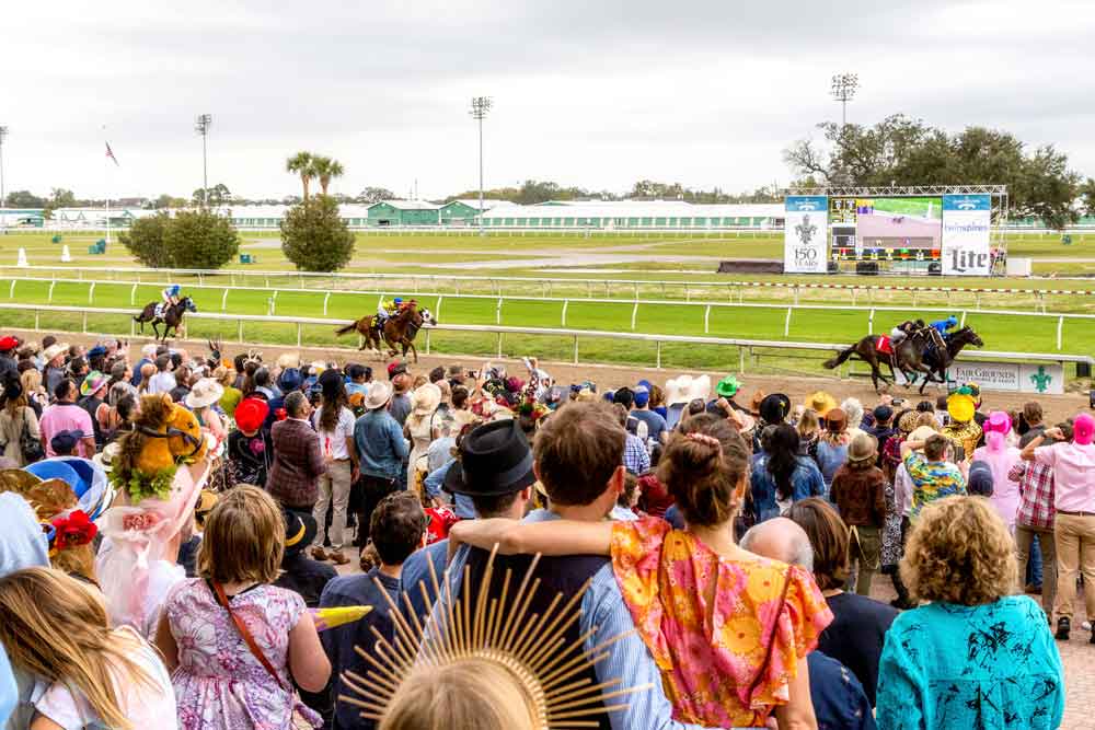 Crowd cheering for horse race at Fair Grounds Race Course & Slots